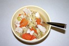A hot, steaming bowl of homemade chunky chicken soup.