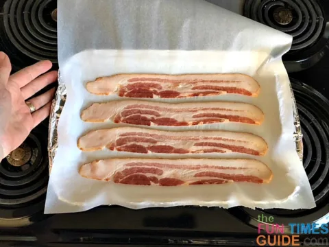 Place pieces of bacon on the parchment paper.