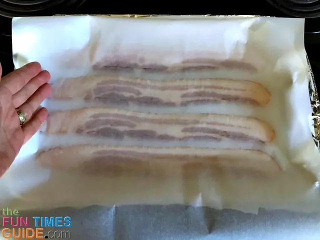 Fold the parchment paper over top of the bacon.