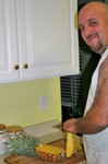 Jim slicing his first fresh pineapple.