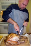 Jim slicing the turkey... with a look that something's gone wrong.