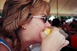 Lynnette eating corn-on-the-cob at the Zellwood Corn Festival.