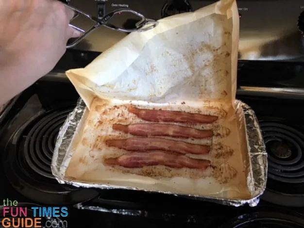 Open up the parchment paper and let it rest until the bacon stops sizzling.