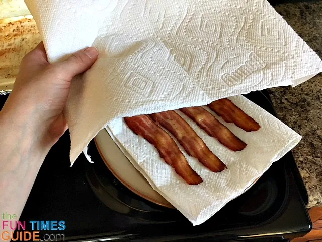 Add few sheets of paper towel on top the bacon to absorb the rest of the grease.