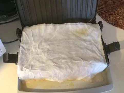 Placing damp paper towels on the George Foreman grill after cooking lifts the grease off the grilling surface for even easier cleaning. 