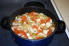 Pot of homemade chicken soup on the stove.