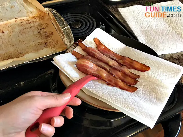 Place the baked bacon on some paper towels to absorb the grease.